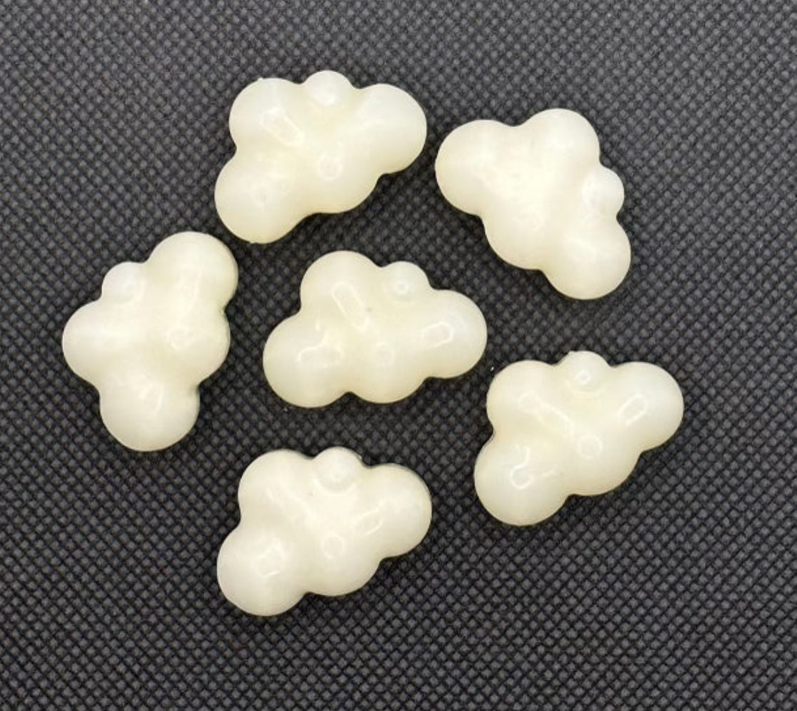 cloud shaped hand poured wax melts on a black background