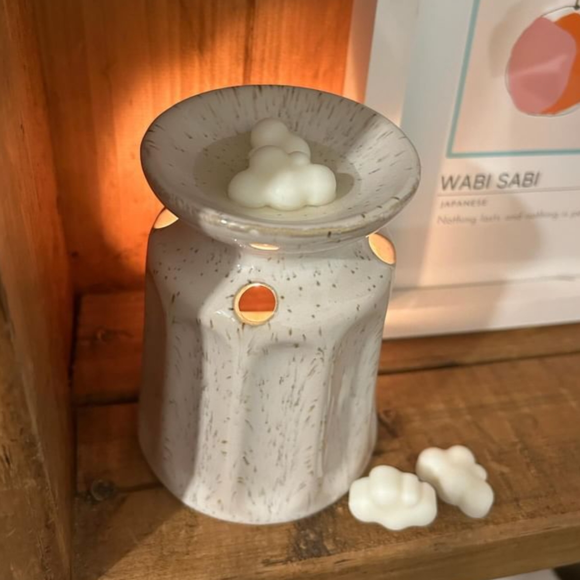 a wax melt burner with a hand poured coconut wax melt in it