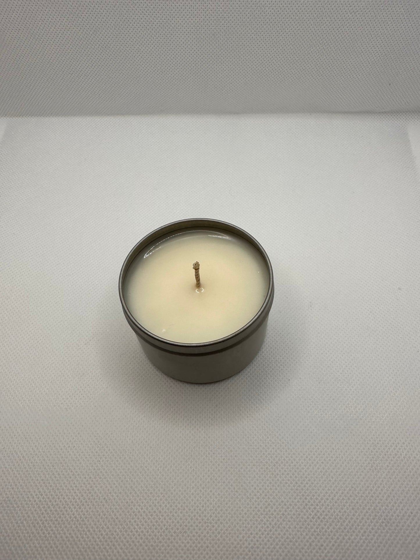 a small hand poured candle on a white background