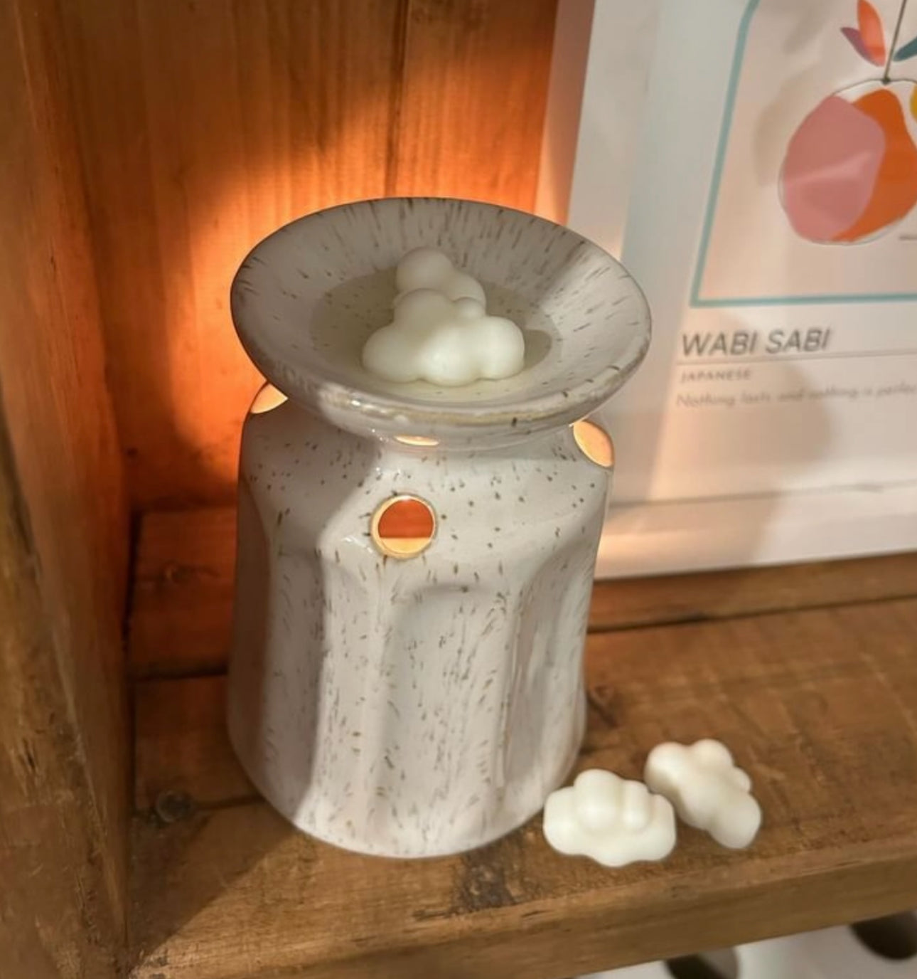 a wax melt burner with a hand poured coconut wax melt in it