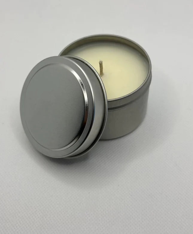 A hand poured candles in a silver tin, smells like candy canes Christmas scent