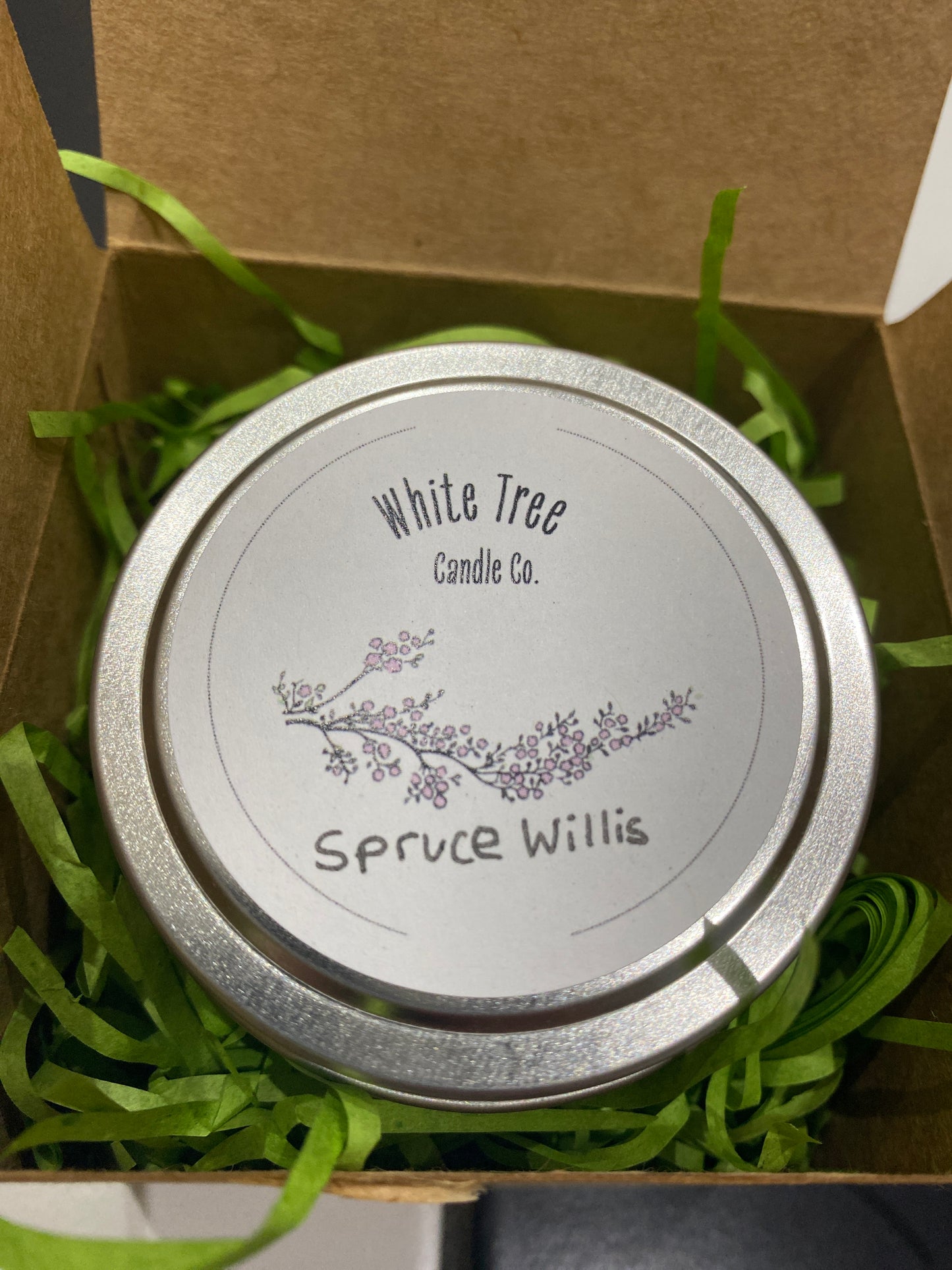 A hand poured candles in a silver tin, spruce willis Christmas scent